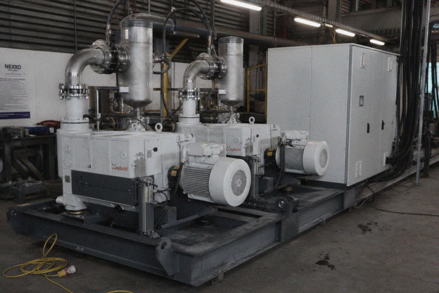 Industrial water-cooled vacuum pump train on a steel skid